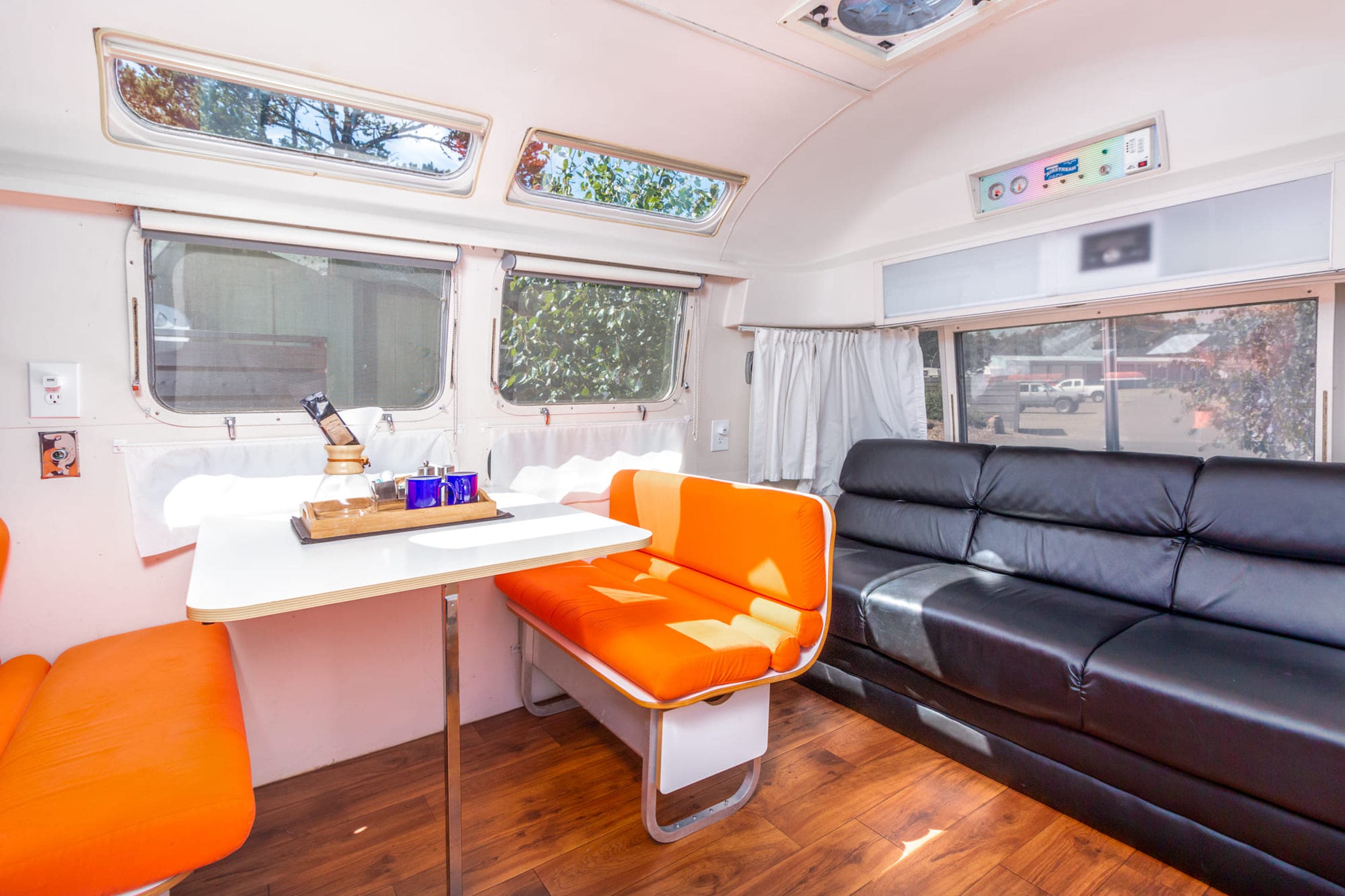 The dining table and couch in a bunk airstream at Harts camp