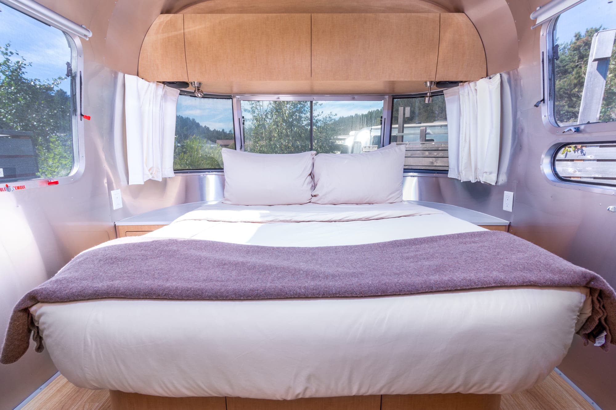 A double bed in a premium airstream at Harts Camp