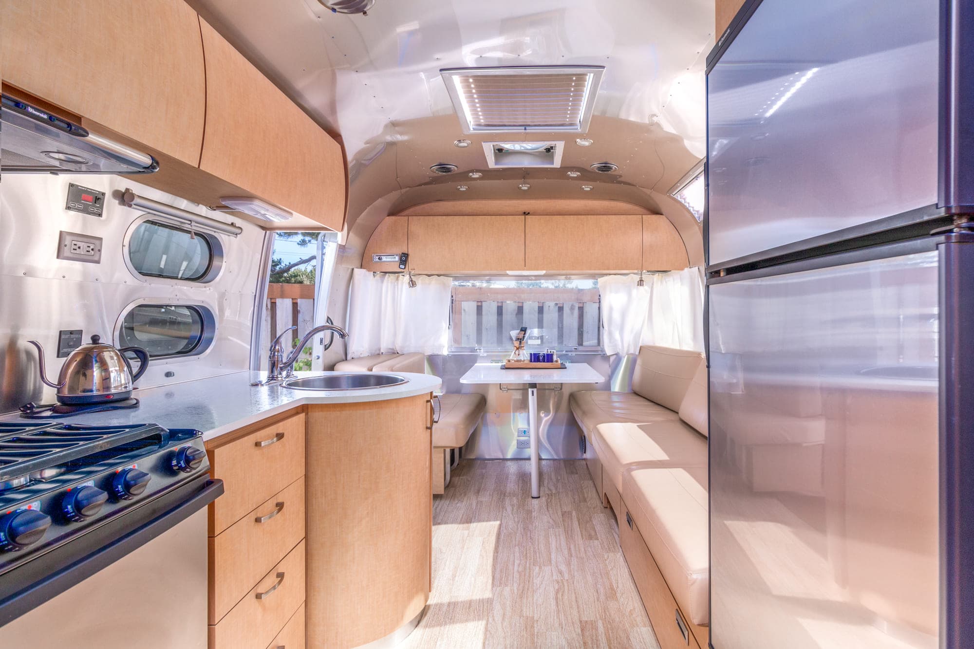 The kitchen and dining area of a premium airstream at Harts Camp