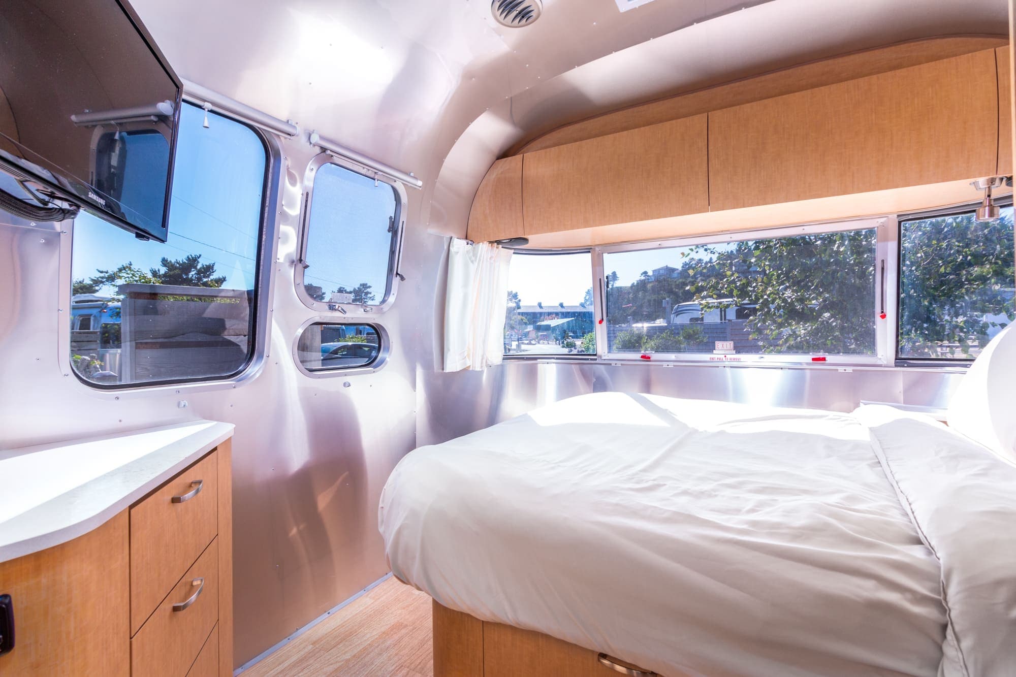 The bedroom with a TV in a standard airstream at Harts Camp