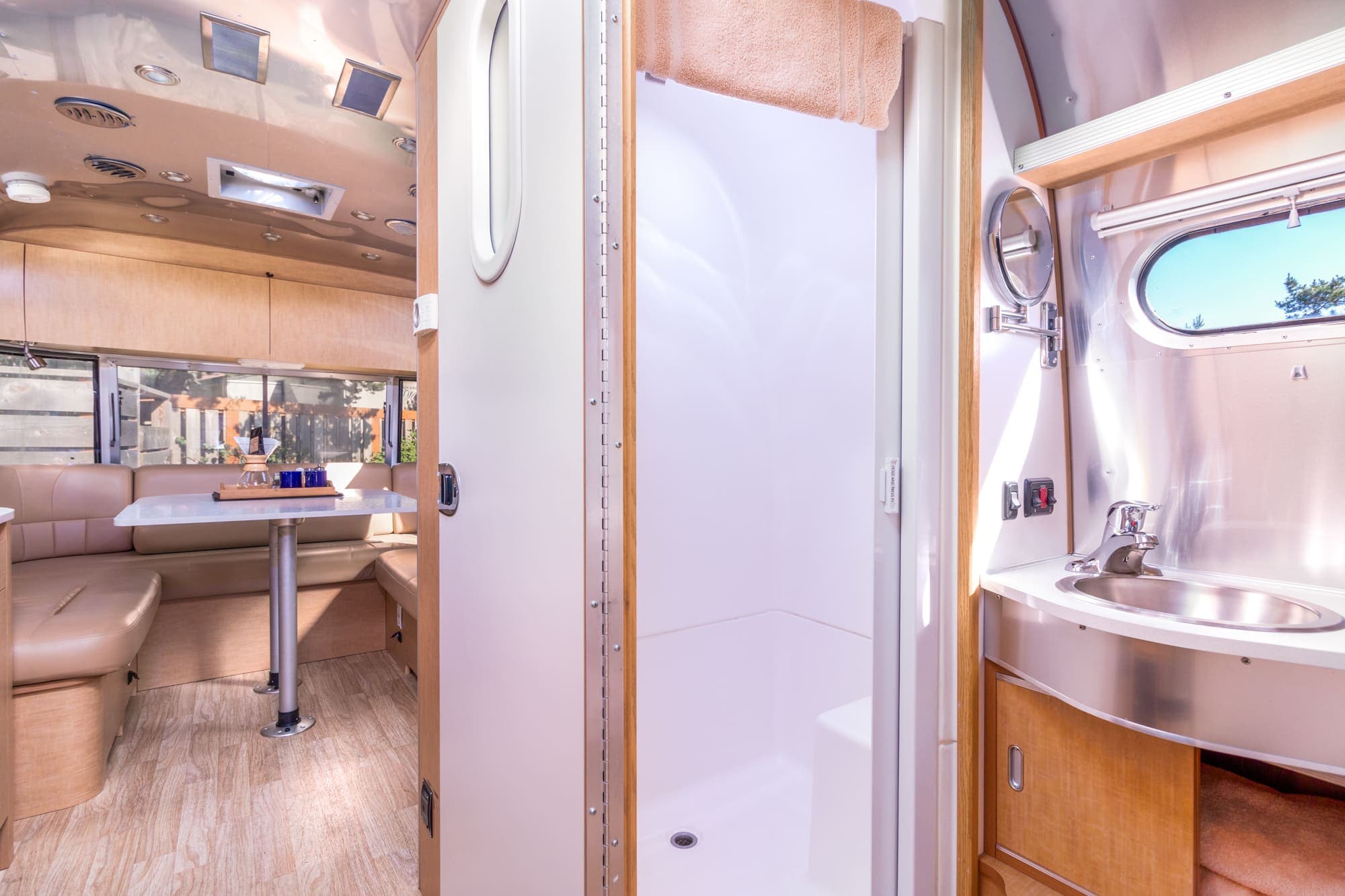 The shower and the vanity of a washroom in a standard airstream at Harts Camp
