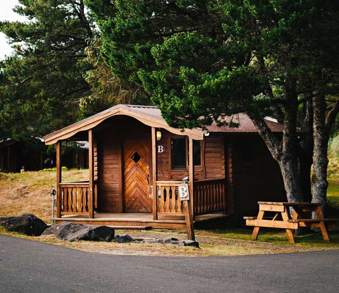 The exterior of a cabin with a picnic table at Harts Camp