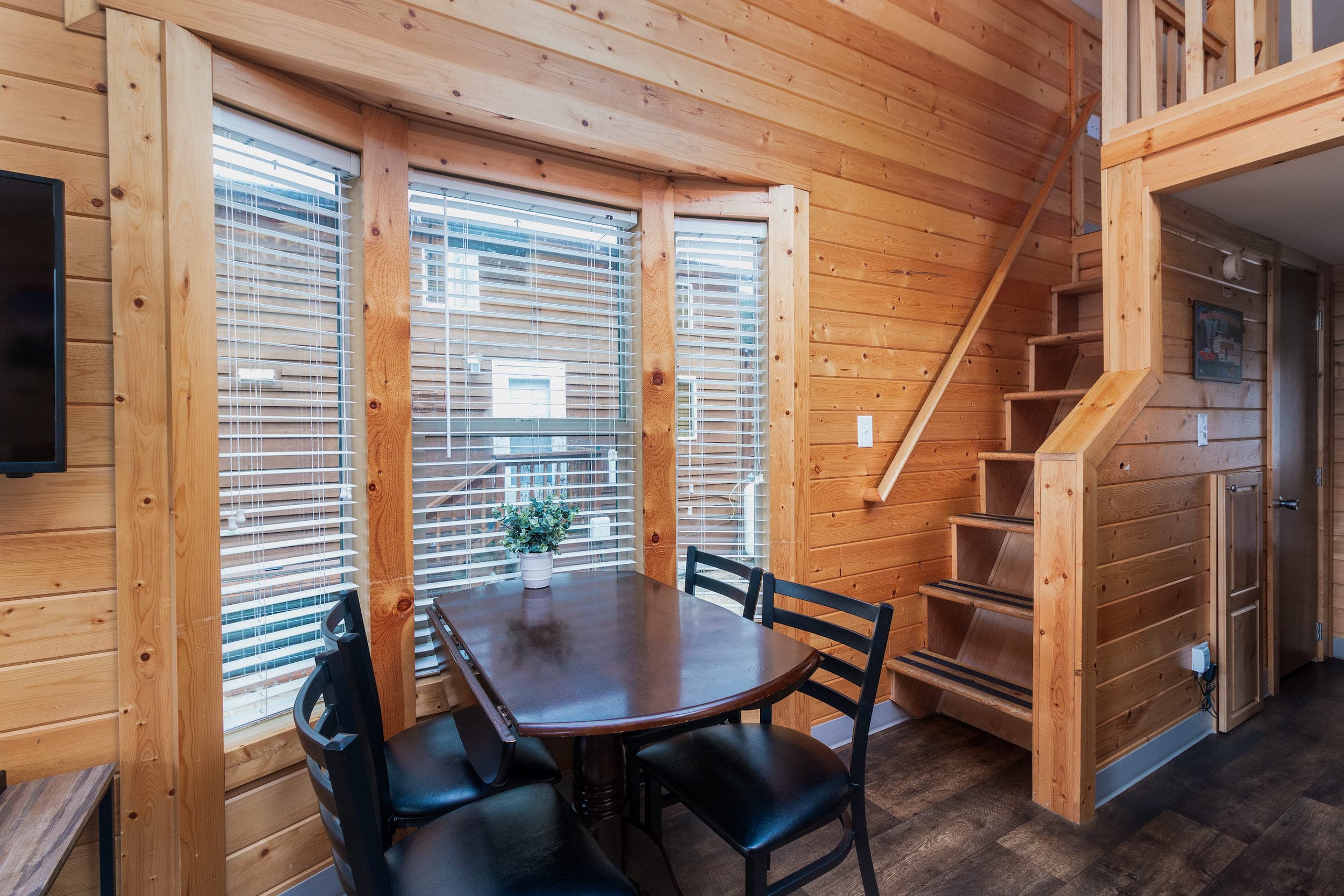 The dining area and stairs to a second level of an accommodation at Hart's Camp, Pacific City, OR