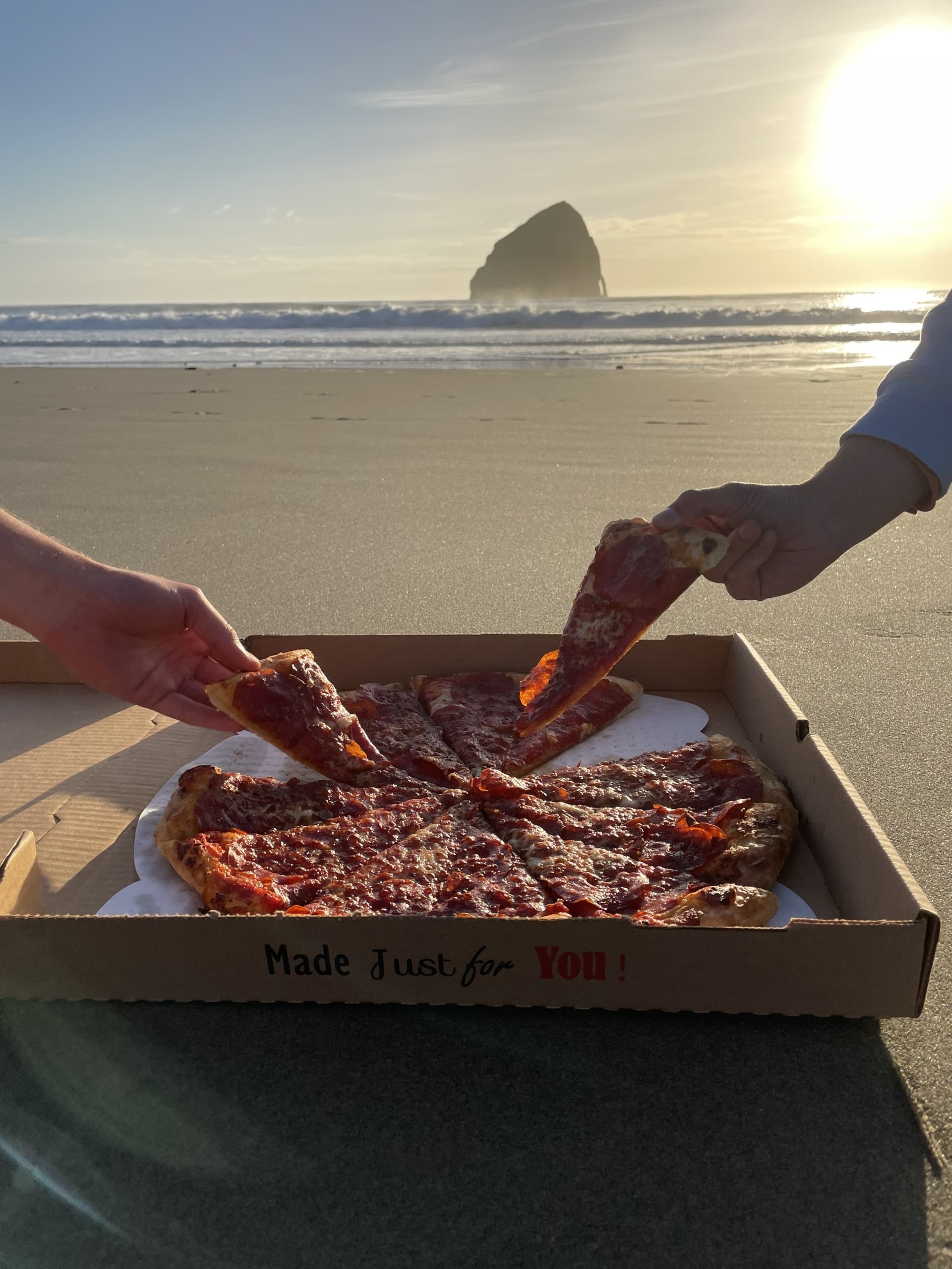 People enjoying Pizza on the beach