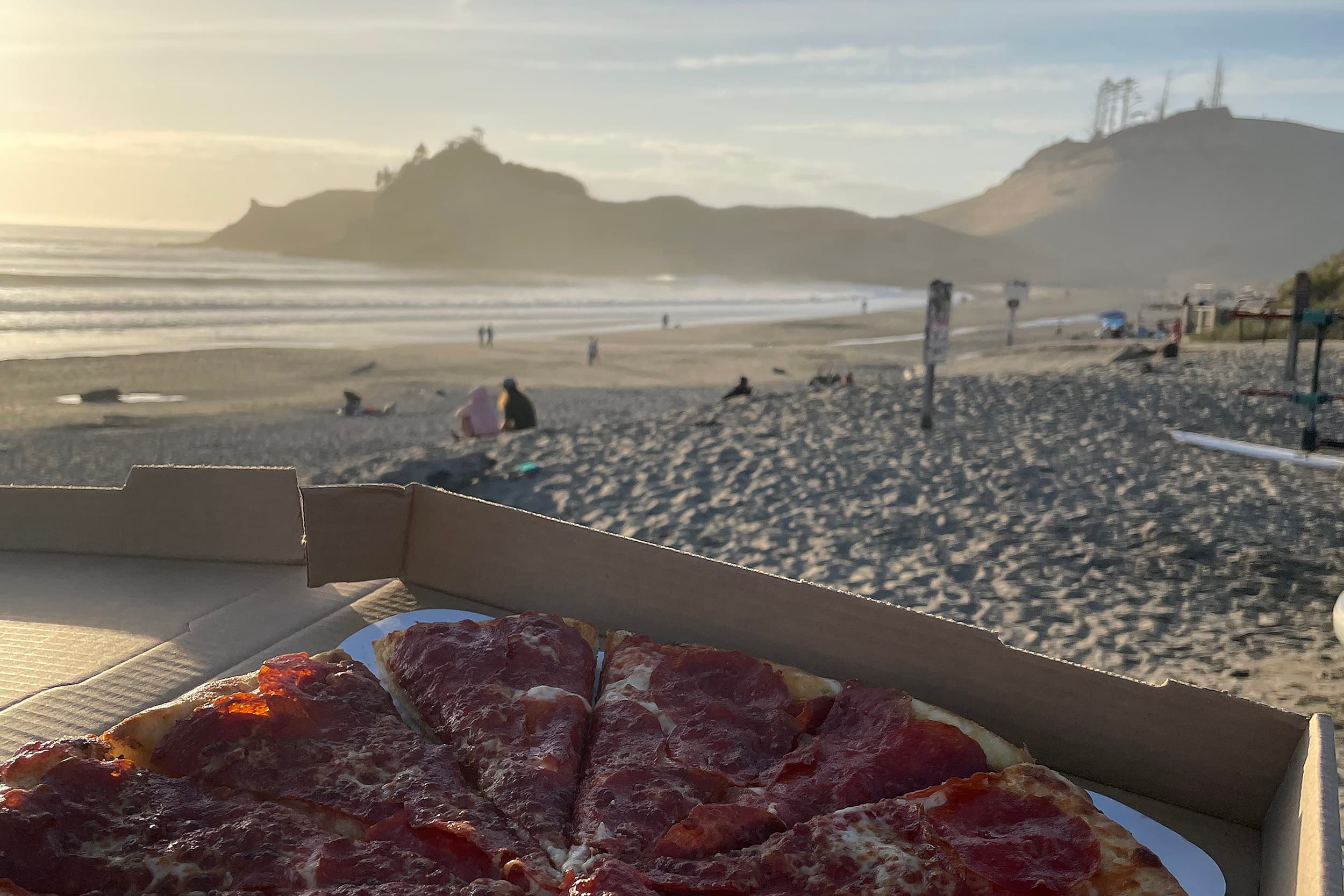 A togo pepperoni pizza in a box on the beach at Hart's Camp