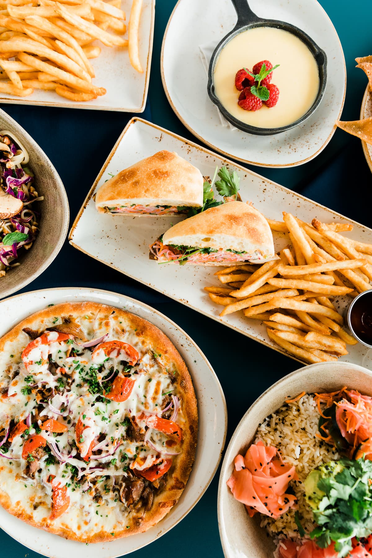 An overview of several different plates of food on a table