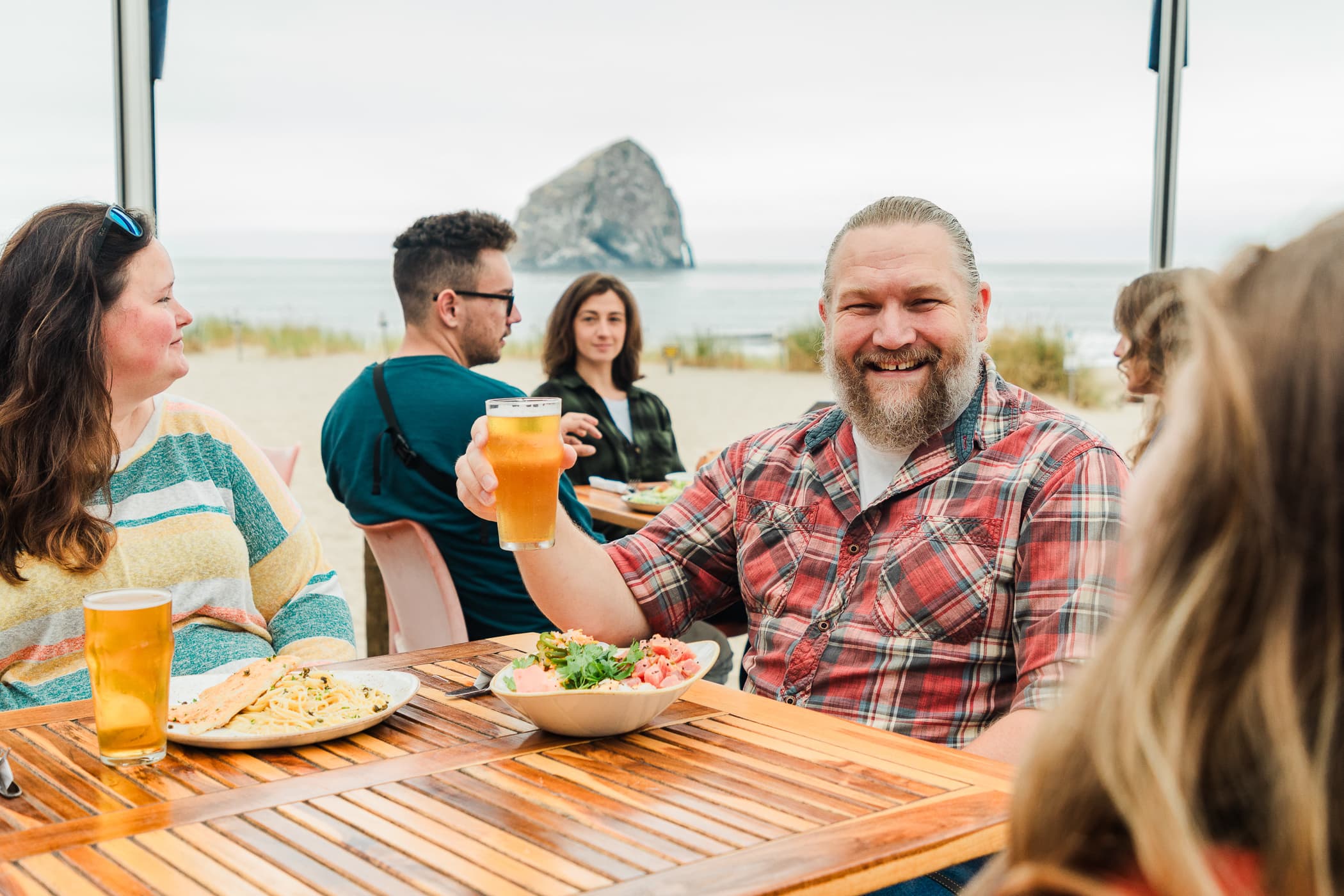 Guests enjoying outdoor dining with Haystack and Pacific Ocean views