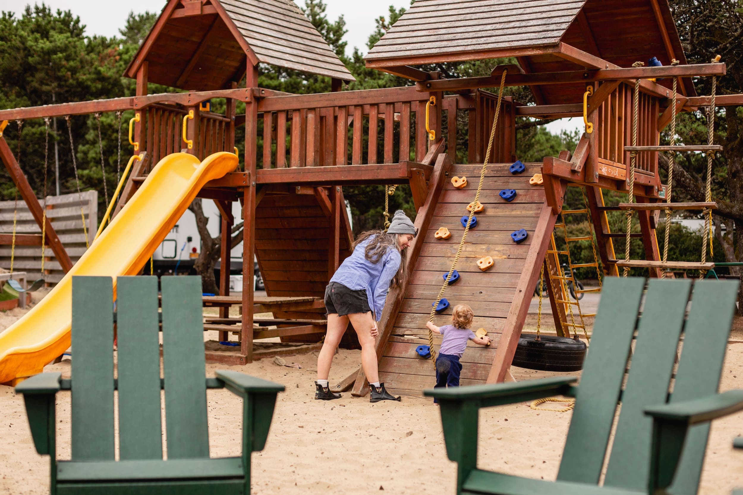A mother and child playing in the playground at Harts Camp