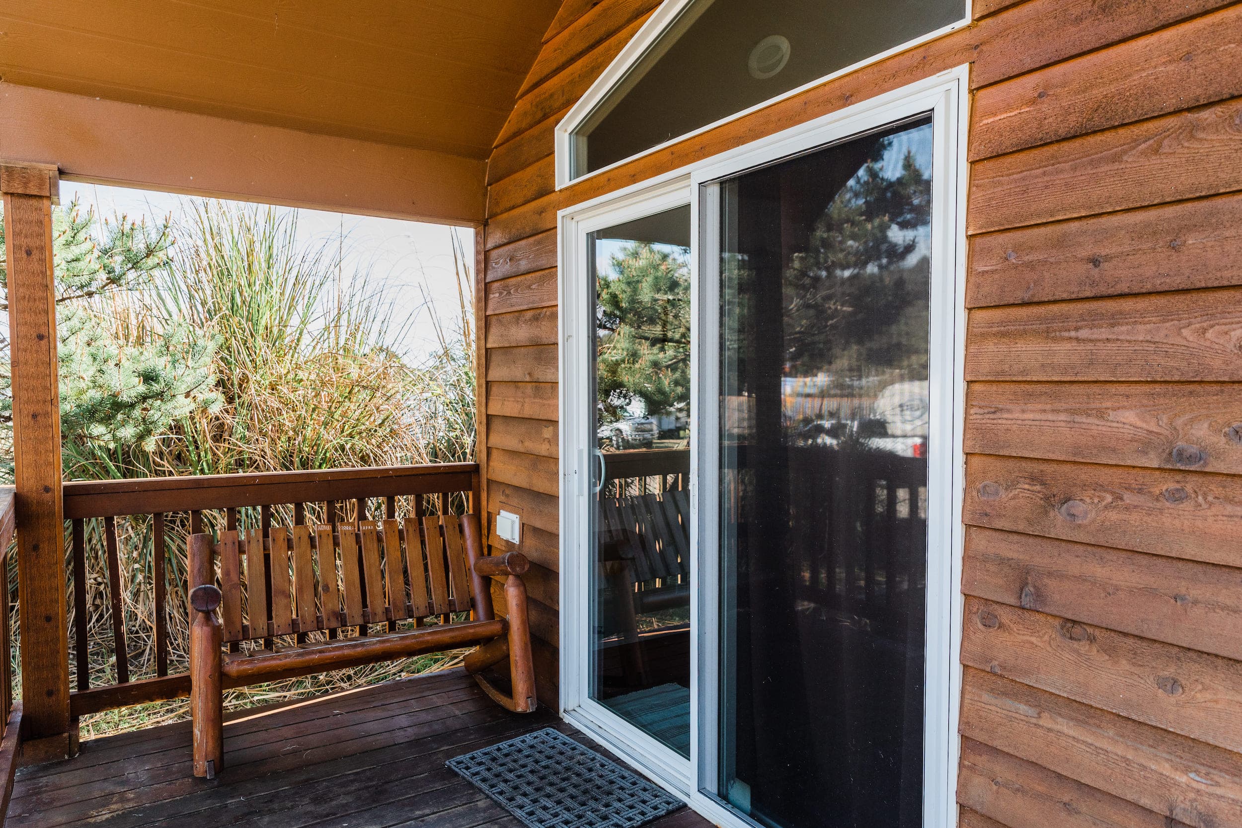 Sliding glass door and porch at a Deluxe Cottage with Bunks at Hart's Camp