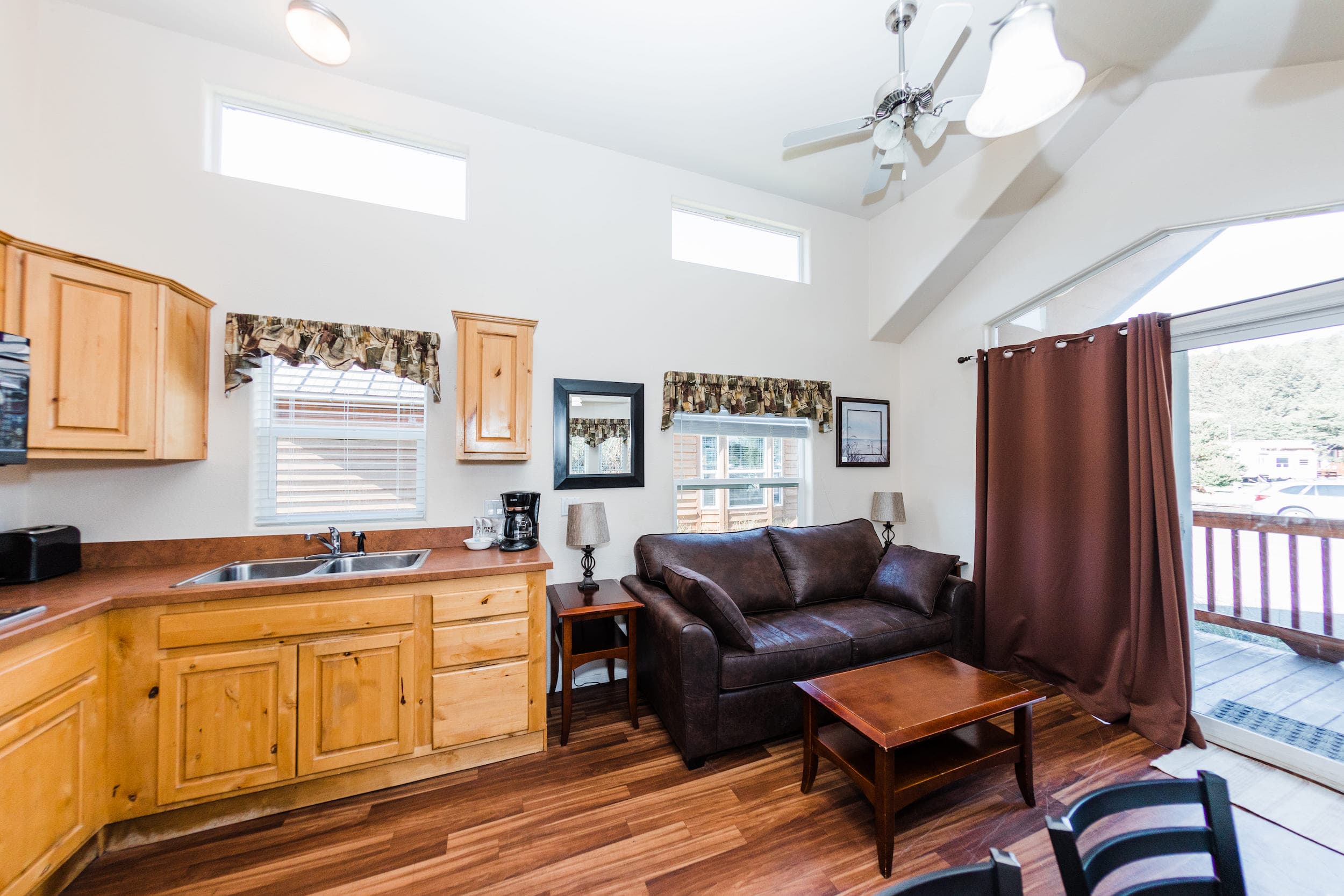 The kitchenette and living area inside a Deluxe Cottage with Bunks at Hart's Camp