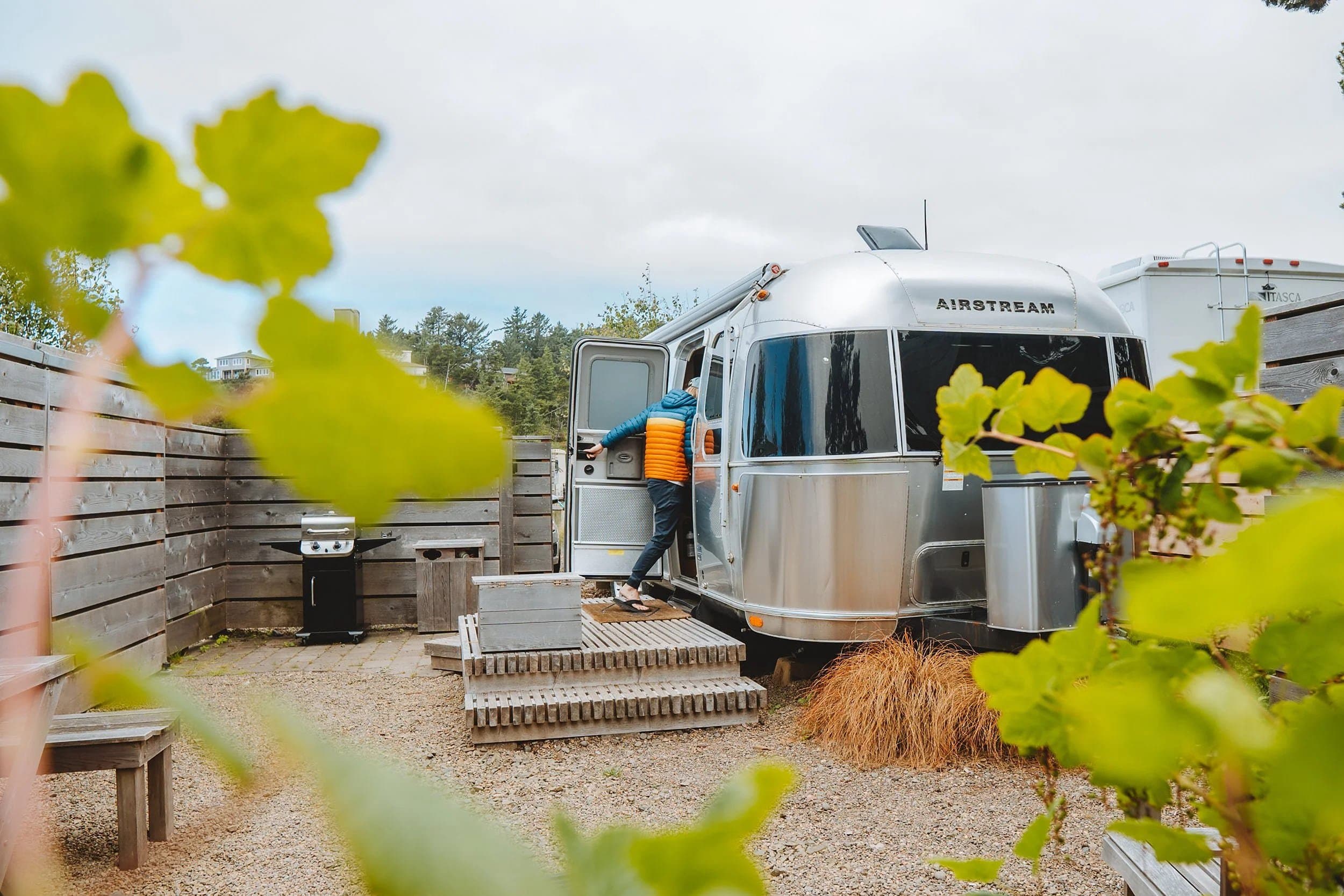 A man entering an Airstream at Hart's Camp