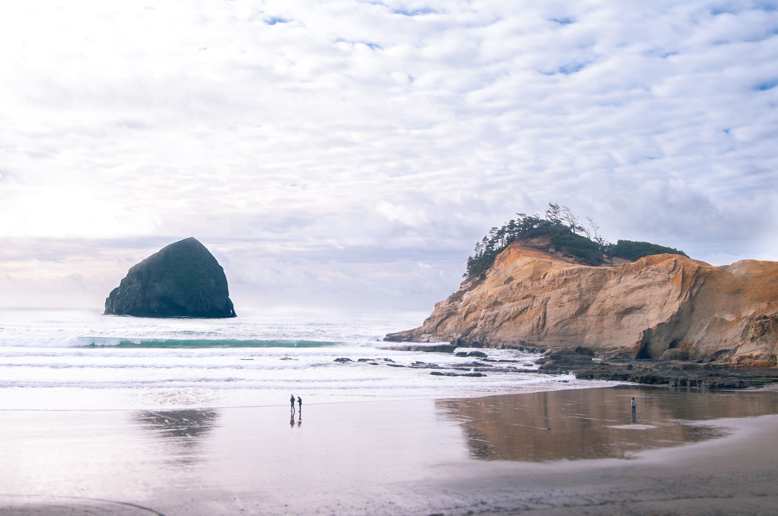 3 people walking on the Pacific City Beach