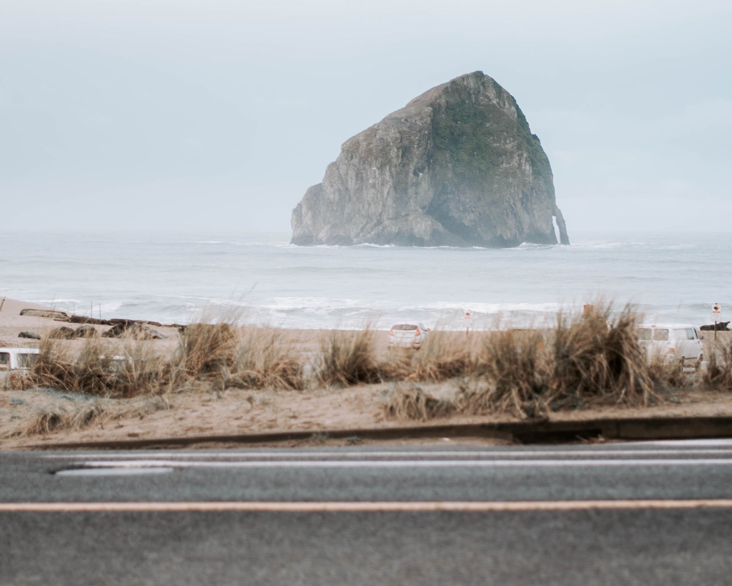 Haystack Rock rising through winter sea mist across the beach from The Inn at Hart's Camp in Pacific City on the Oregon Coast