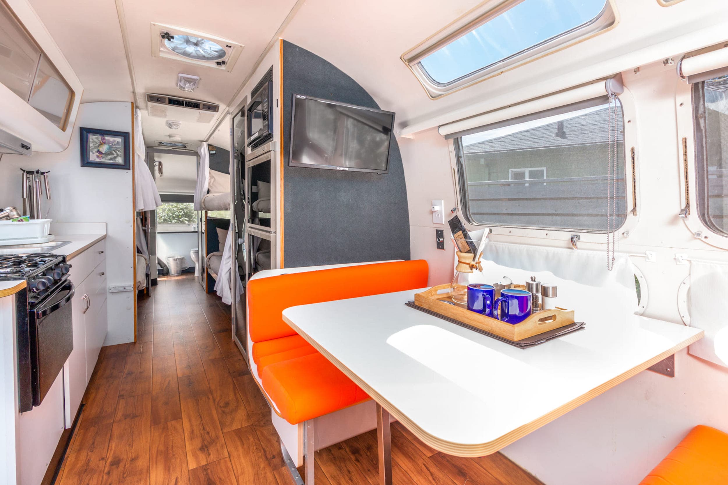 The kitchen and dining area of a bunk airstream at Harts Camp