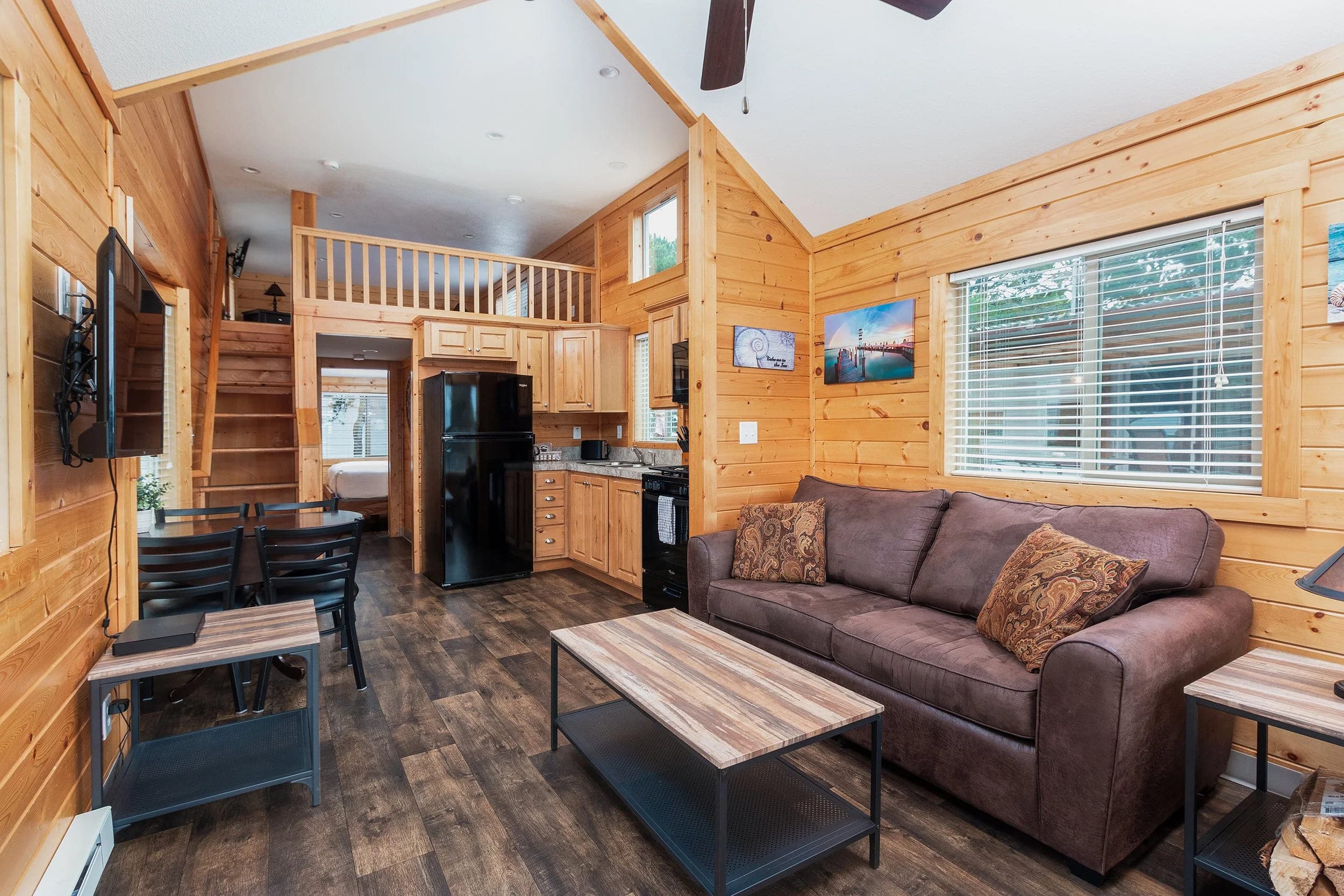 The inside of a Hart's Camp cottage with a loft bedroom and an open concept living space