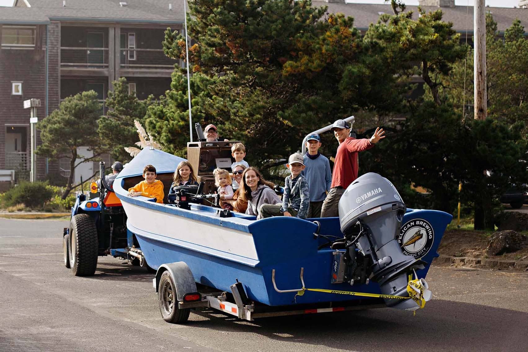 A boat float with a bunch of kids and family for Hart's Camp Events Dory Boat Ride