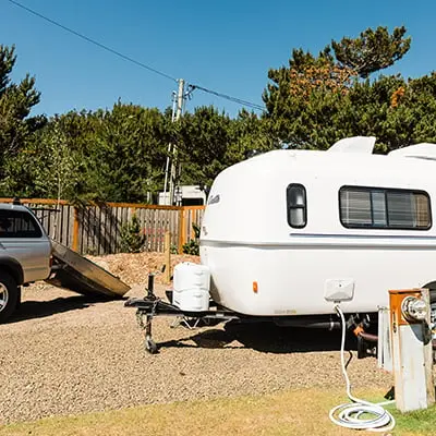 A camper on the RV site at Hart's Camp plugged into the electrical outlet