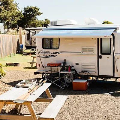 A camper on the RV site at Hart's Camp with a picnic table and camping stove