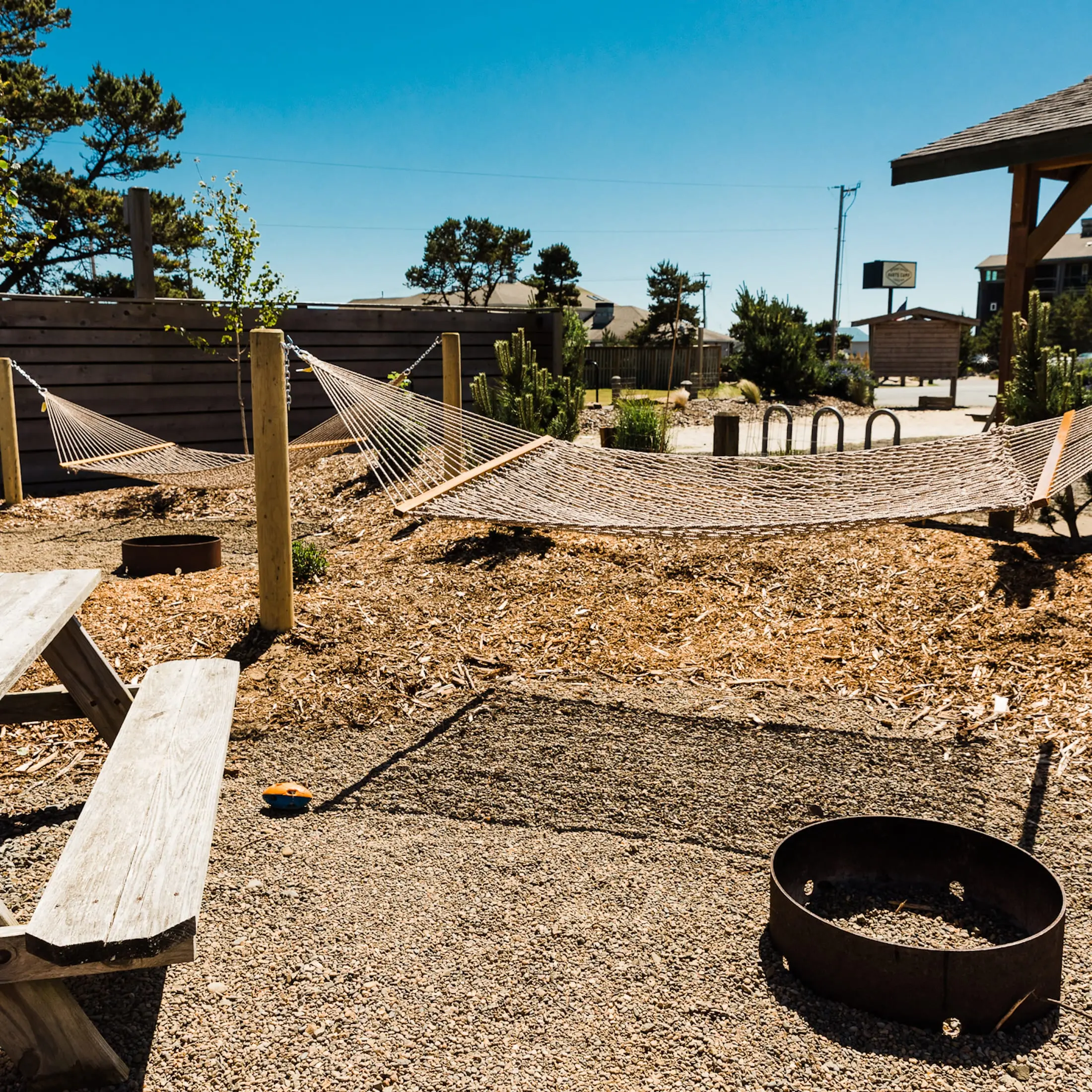 Hammocks, a fire pit, and picnic table at a camp site at Hart's Camp, Pacific City, OR.