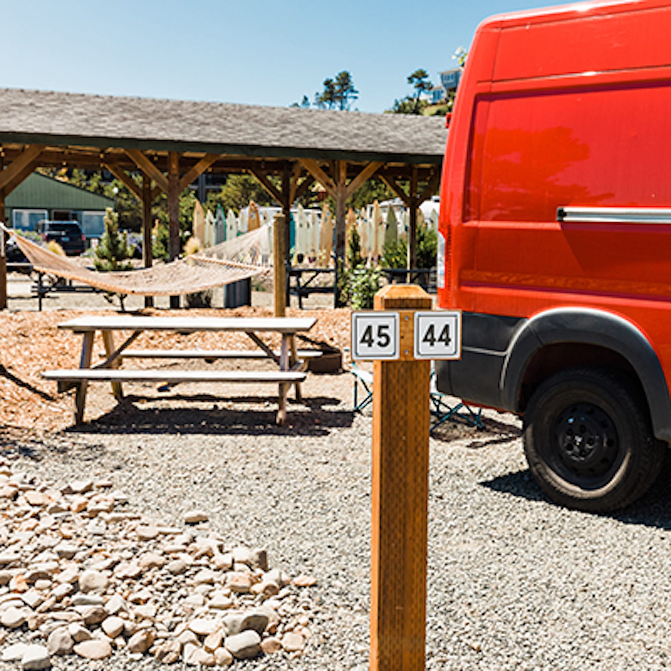 A red van parked at a van site at Hart's Camp, Pacific City, OR.