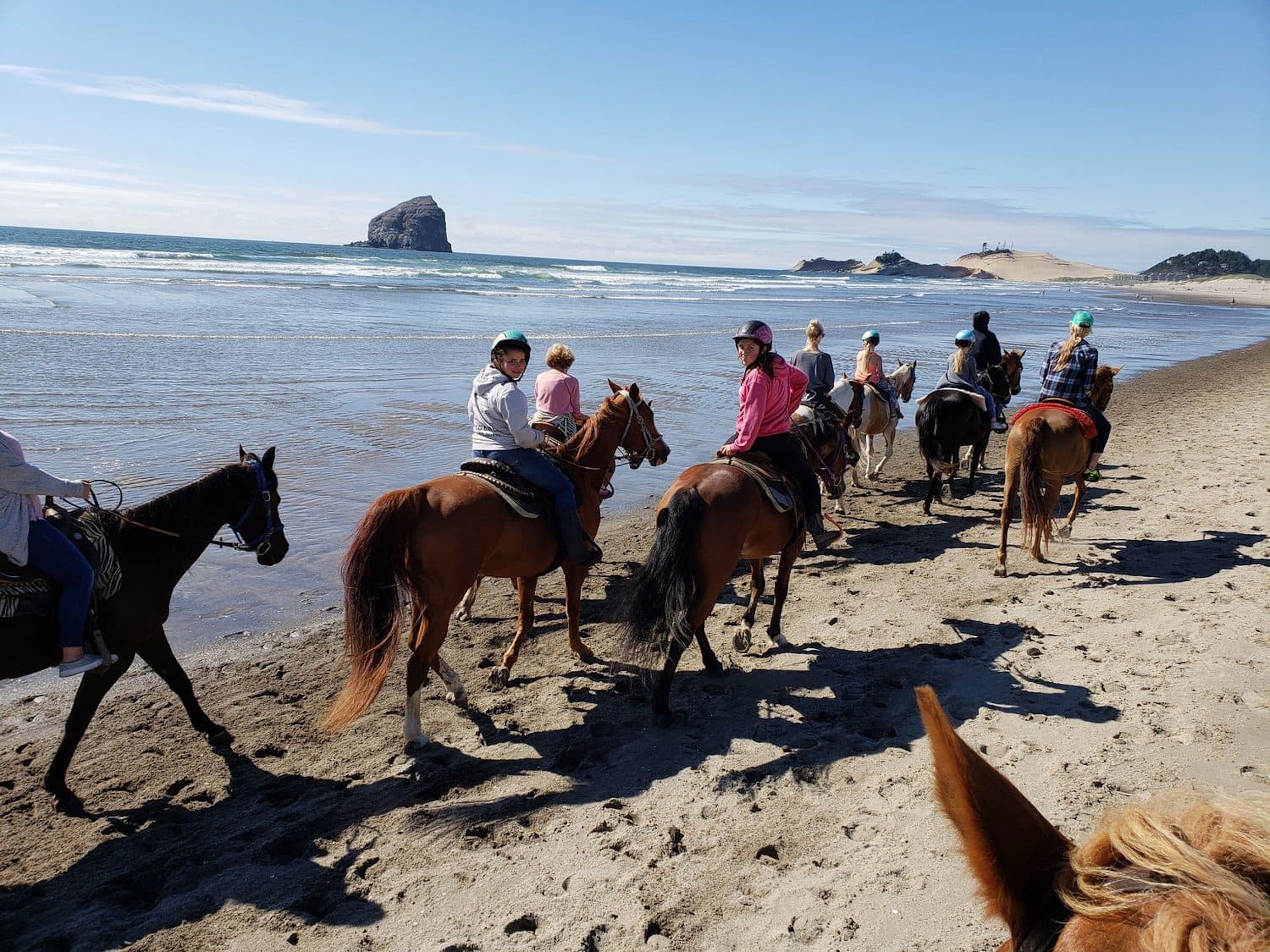 A group of people on a Horseback Ride On The Beach Near Hart's Camp