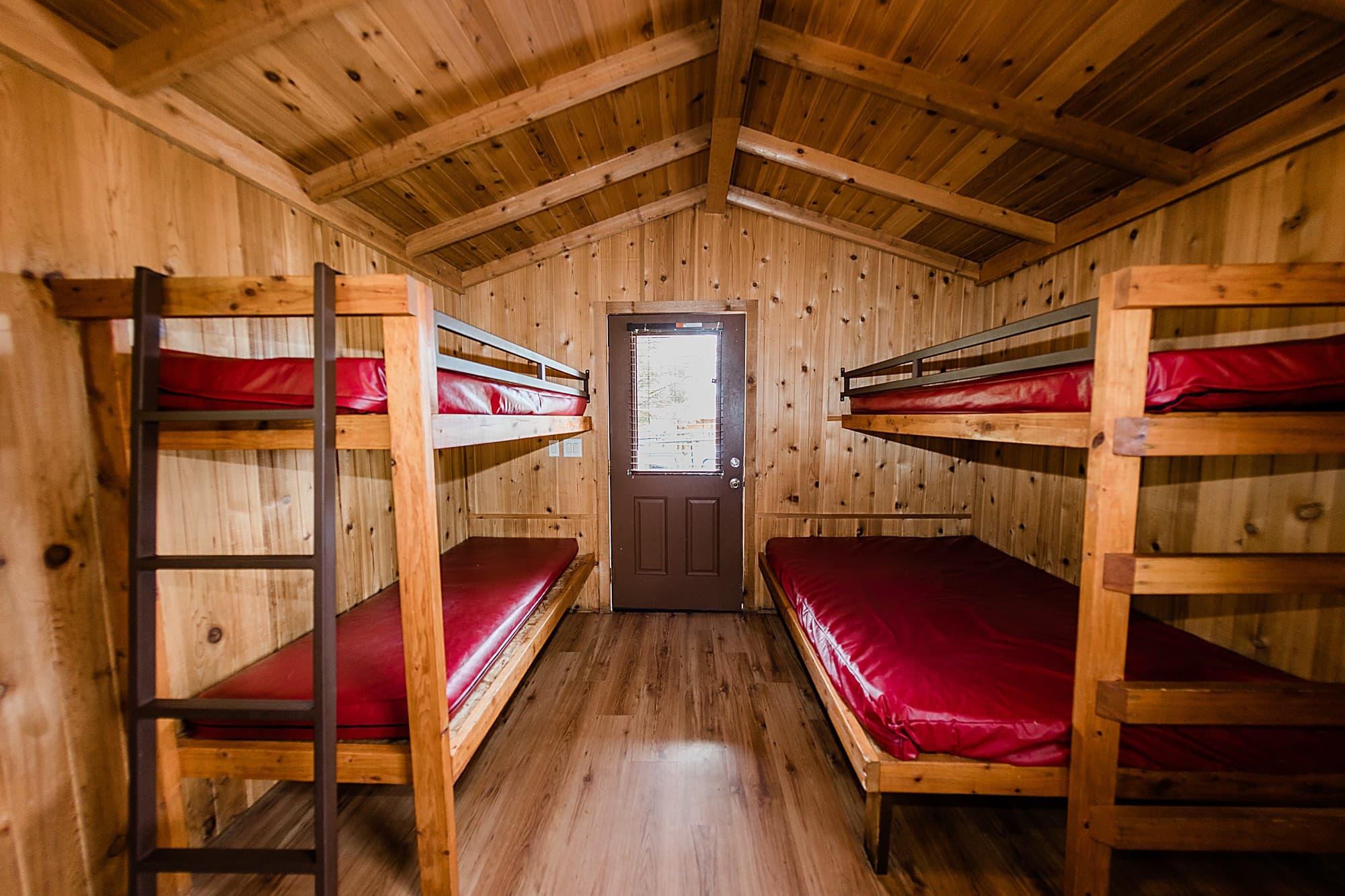 Two sets of bunk beds in a cedar-lined camping cabin at Hart's Camp near Haystack Rock on the Oregon Coast