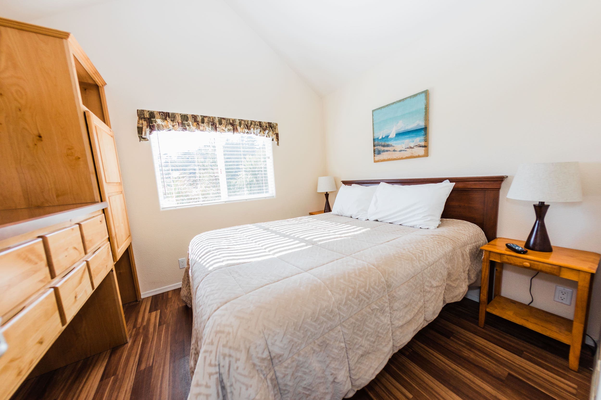 The queen bed inside of a Deluxe Cottage with Bunks at Hart's Camp