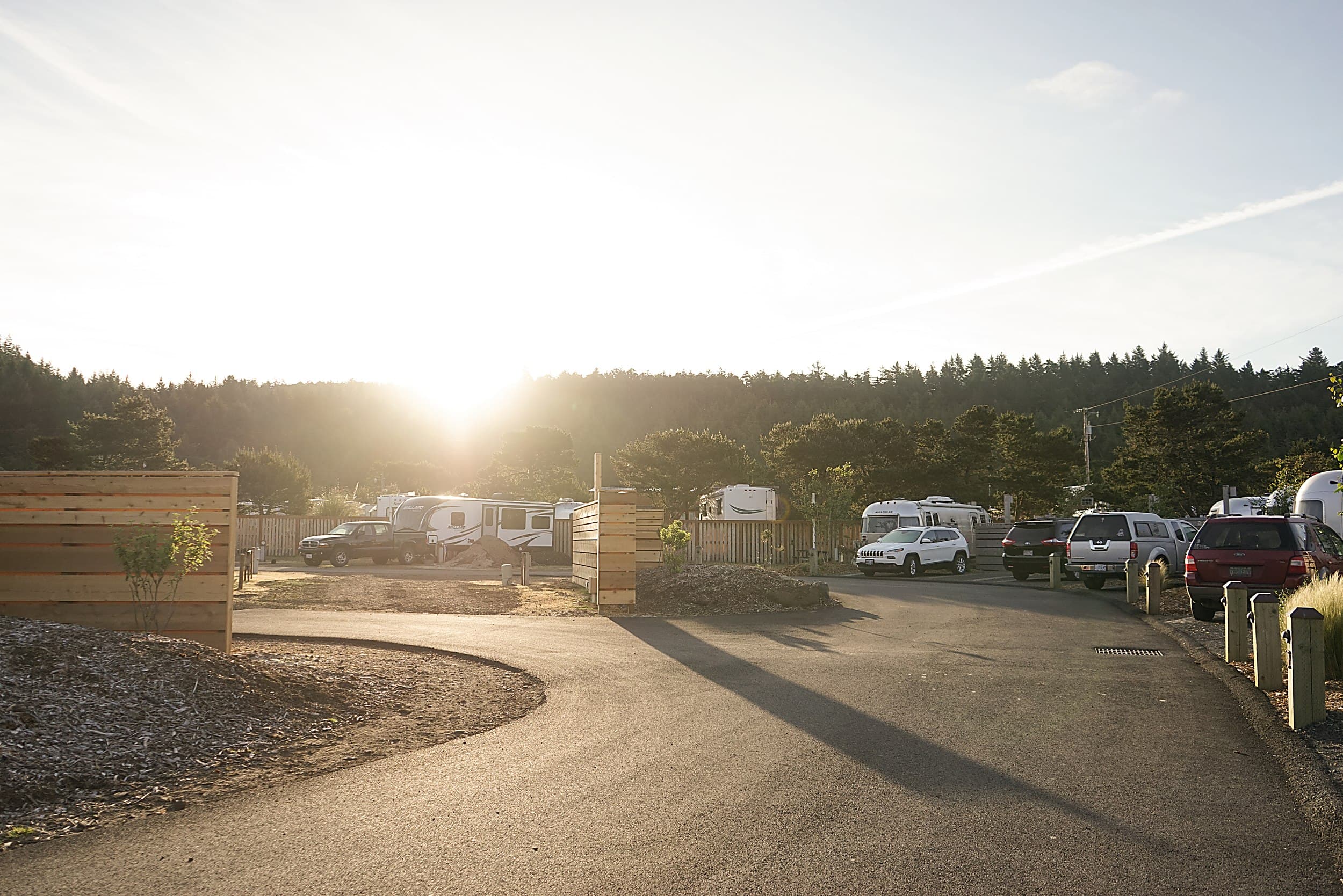 Golden hour light over RV and Airstream sites at The Inn at Hart's Camp, a pet-friendly glamping resort on the Oregon Coast