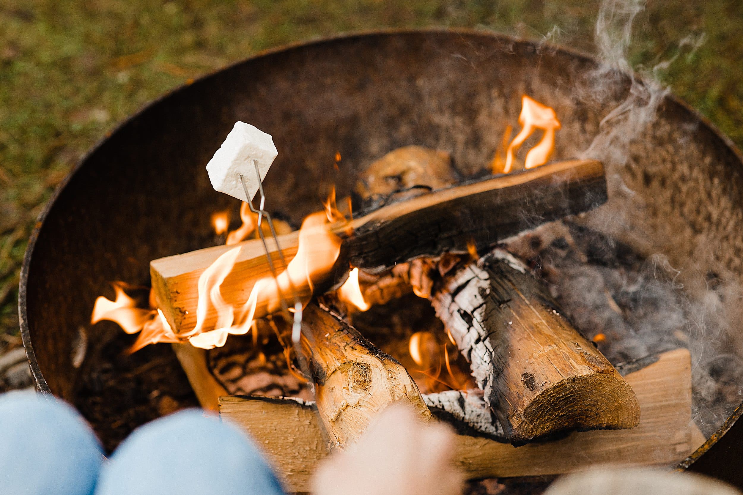 Marshmallow toasting over an open campfire at The Inn at Hart's Camp, a Pacific City, Oregon glamping and RV destination on the Oregon Coast.
